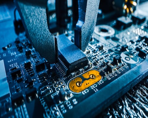 machine working on a printed circuit board