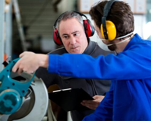 factory employees working with rotary tool