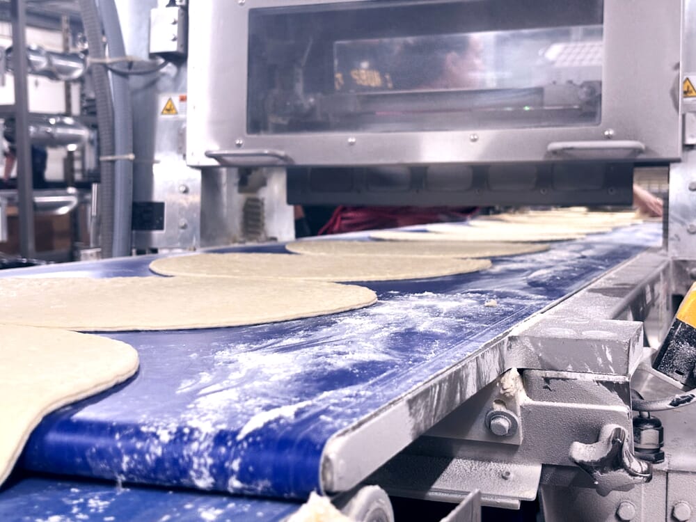 An oil-flooded screw compressor with food-grade lubricant works for The Fire Roasted Crust Co. in Wexford, PA, because the air does not come into contact with the food products.