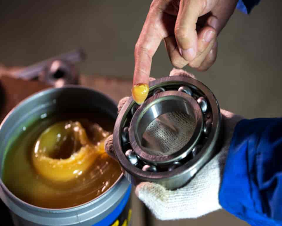 putting grease on mechanical bearing