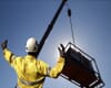 crane lifting an industrial compressor
